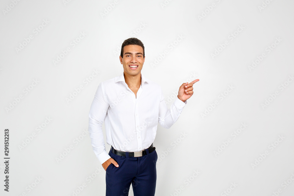 Handsome African-American businessman pointing at something on white background Handsome African-American businessman pointing at something on white background