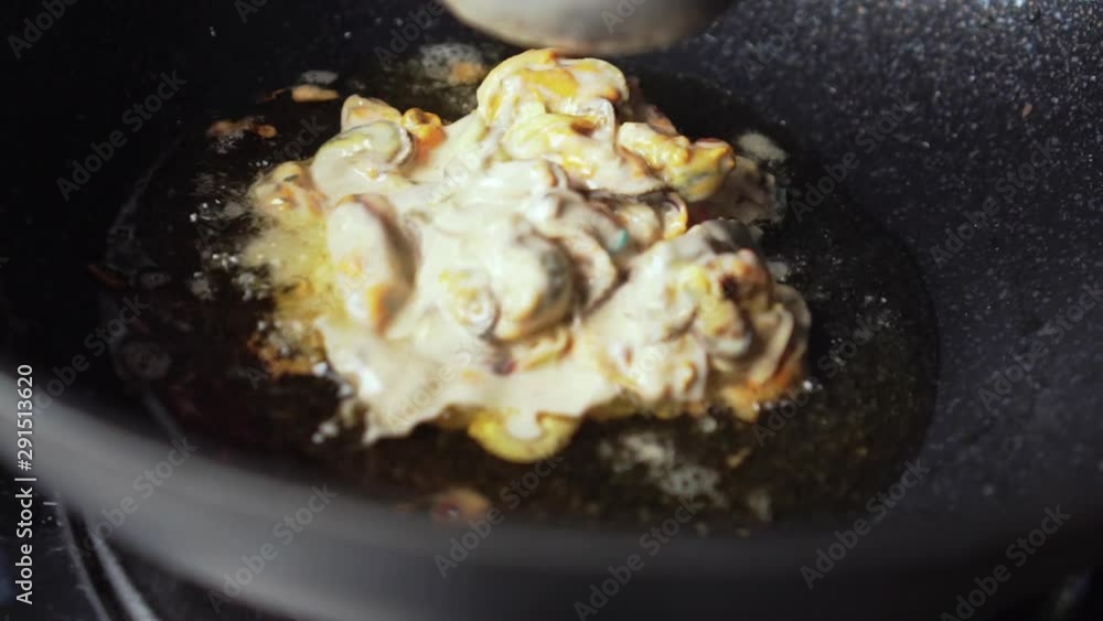 Making of mussels fried in egg batter. Asian food. Thai food. add in. slow motion. Making of mussels fried in egg batter. Asian food. Thai food. add in. slow motion.