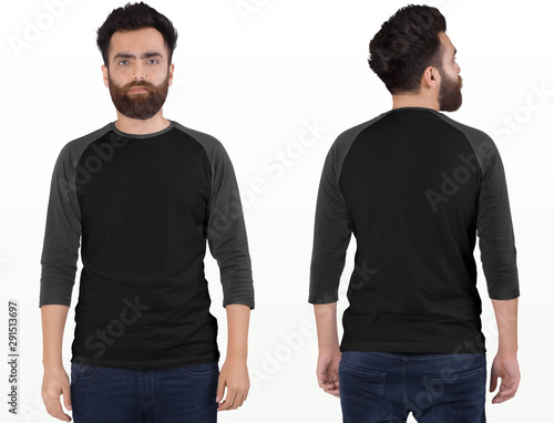 Bearded male model wearing white and grey 3/4 sleeve raglan shirt in dark blue denim jeans pant. isolated background