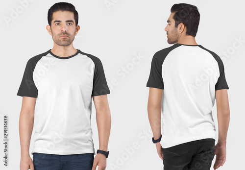 Front and back view of standing handsome male model wearing white and grey plain raglan t shirt in dark blue denim jeans pant. Isolated background.