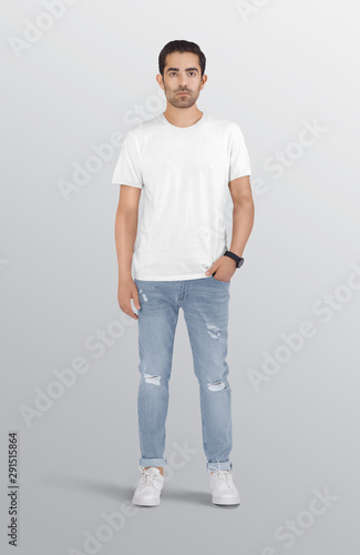Standing male model wearing white plain crew neck t shirt in ripped blue denim jeans pant. Isolated background.