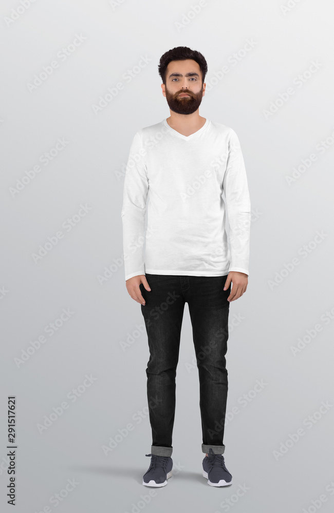 Fototapeta premium Standing man wearing white blank v neck long sleeve shirt in black jeans pant. Isolated background