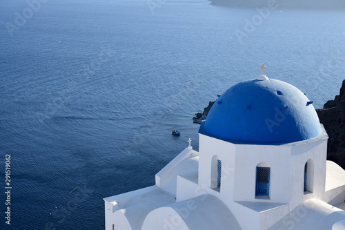 Blue and white church and Aegean Sea on Santorini island, Greece