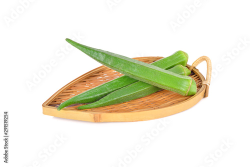 fresh okra in bamboo plate with white background © yodaswaj