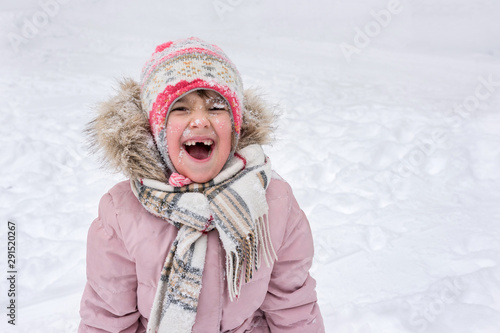  Winter portrait of a happy child outdoors in winter.