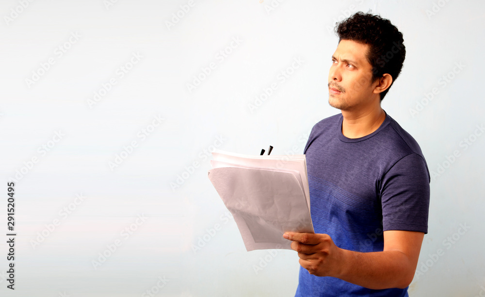 Portrait of a handsome asia man holding book isolated on a white background. Portrait of a handsome asia man holding book isolated on a white background.