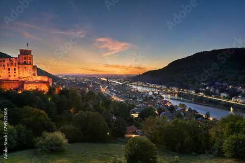Hstoric city of Heidelberg with the castle on the hill and bridge over the Neckar river during beautiful sunset photo