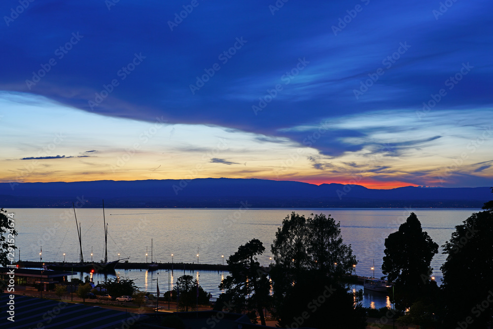 Colorful sunset sky over Lake Geneva in Evian-les-Bains, Haute-Savoie, France Colorful sunset sky over Lake Geneva in Evian-les-Bains, Haute-Savoie, France