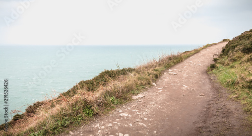 hiking trail on cliff skirting the sea in Howth