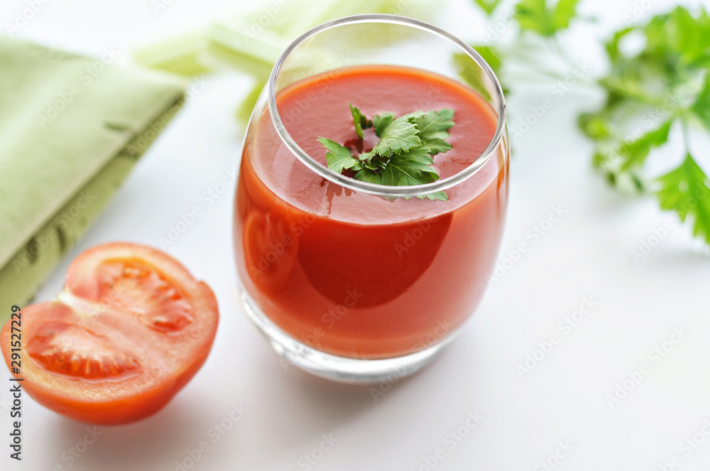Tomato juice poured into a glass, and parsley. Selective focus Tomato juice poured into a glass, and parsley. Selective focus