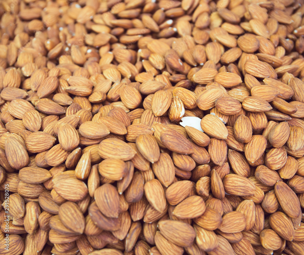 Peeled almond nuts at the market close up. Selective focus. Healthy food concept background Peeled almond nuts at the market close up. Selective focus. Healthy food concept background