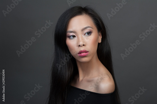 Studio portrait of young asian woman