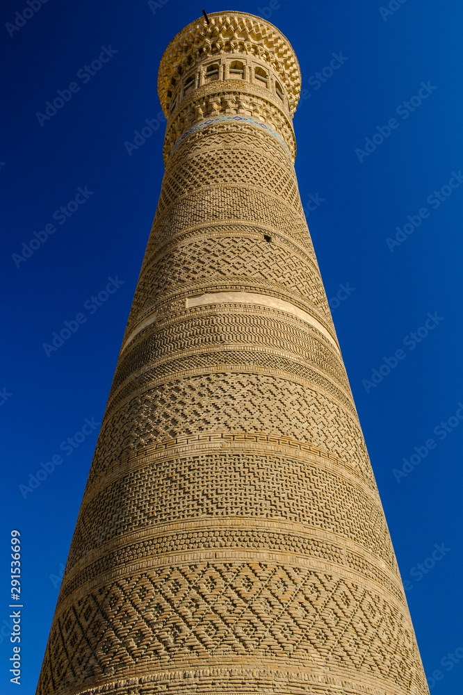 Kalyan minaret in Bukhara. Old ancient minaret on the sky background. Central Asia travel view.