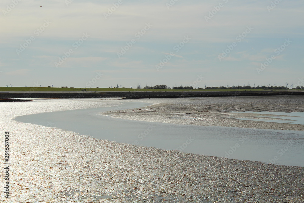 Obraz premium The Wadden Sea near Bensersiel, Northern Germany, at low tide - UNESCO World Heritage Site