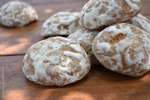 Heap of honey-cake on wooden table. Russian spice-cakes with frosting. Closeup.