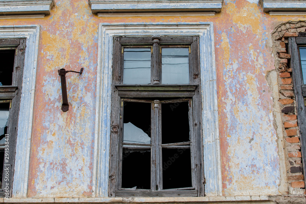 Broken windows on old abandoned residentual house in Transylvania, Romania.