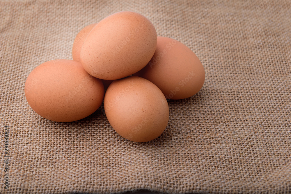 Fresh eggs on sackcloth. Copy the area for the text on the background, sackcloth, brown. Fresh eggs on sackcloth. Copy the area for the text on the background, sackcloth, brown.