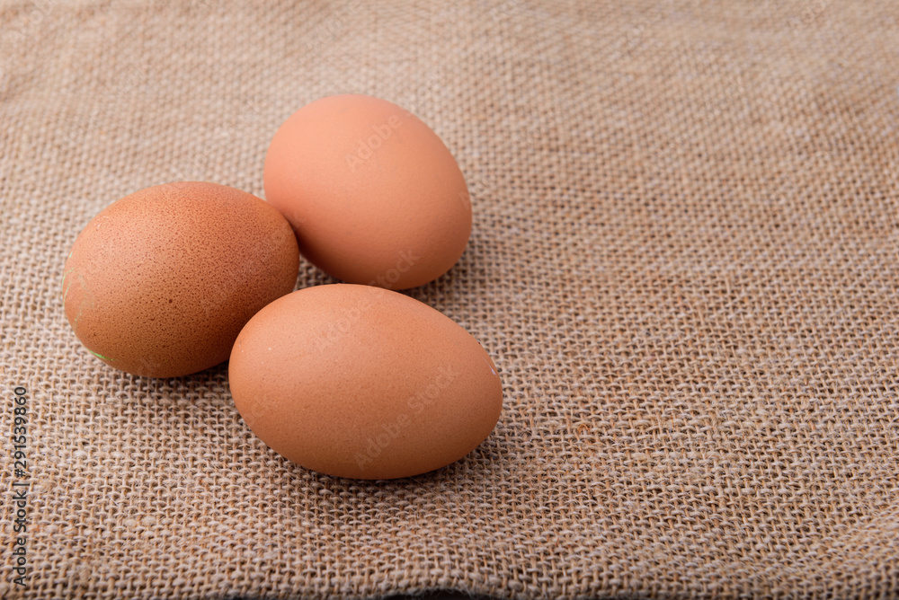 Fresh eggs on sackcloth. Copy the area for the text on the background. Fresh eggs on sackcloth. Copy the area for the text on the background.