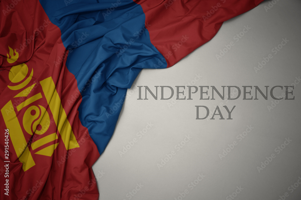 waving colorful national flag of mongolia on a gray background with text independence day.