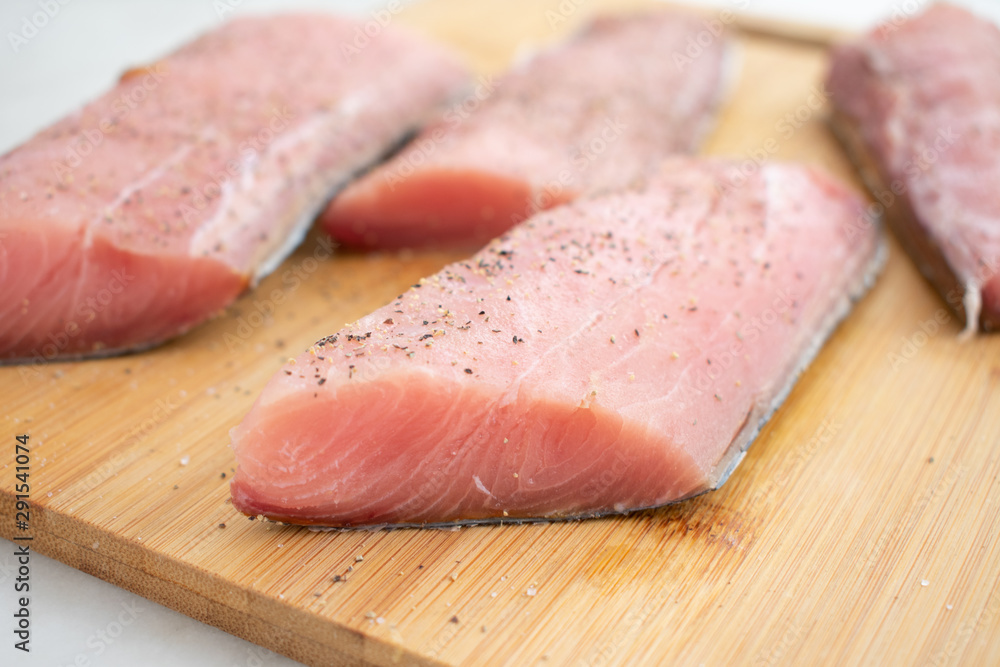 Raw Mahi Mahi (Dolphin Fish) Fillets on a Cutting Board Raw Mahi Mahi (Dolphin Fish) Fillets on a Cutting Board
