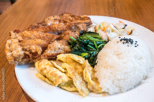 Taiwanese food gourmet fried chicken with rice , bento/boxed meal in wood background