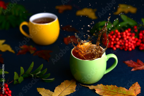 Autumn tea with rowan on blue handmade table