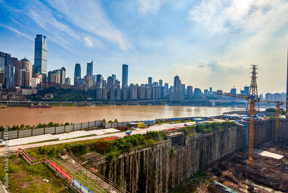 High-rise buildings and construction sites along the Yangtze River in Chongqing