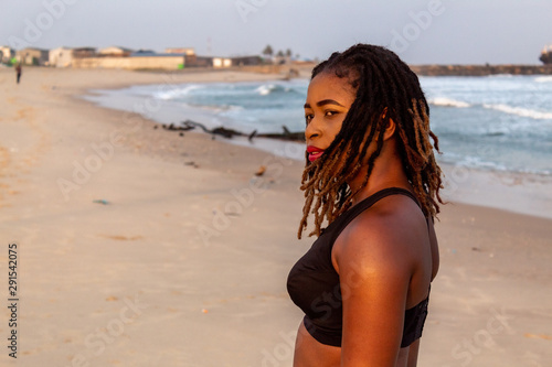 Closeup of young African lady in sportswear on the beach
