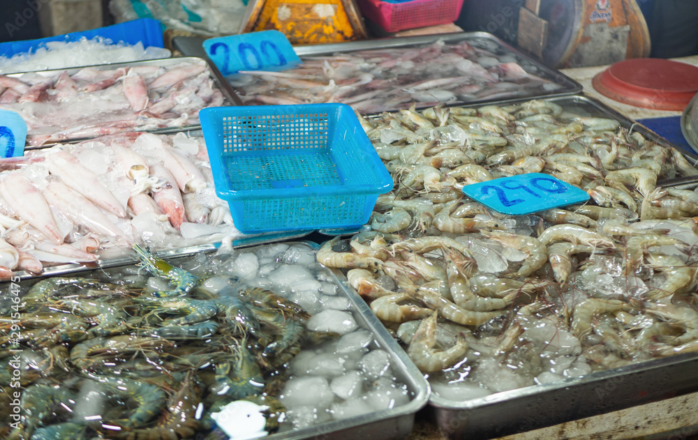 Fresh shrimps, squids with prices at seafood market