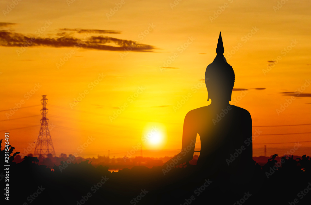 The large Silhouette Buddha on golden sunset background. Sky morning in Asia Thailand