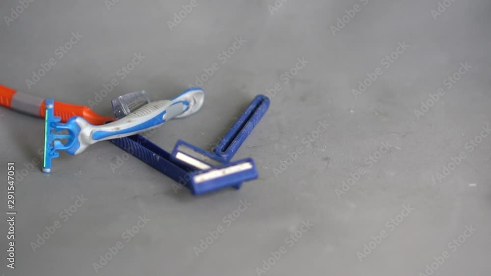 Person throws out used plastic disposable razors. Zero waste concept. Recycling challenge Person throws out used plastic disposable razors. Zero waste concept. Recycling challenge