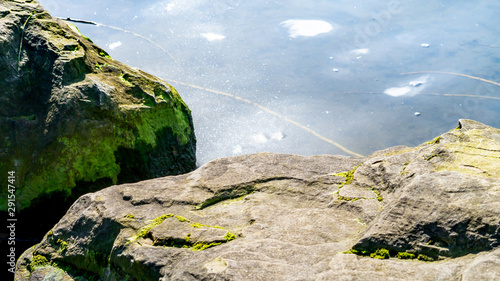 Rocks next to a lake at Herrington Country Park in Sunderland. photo