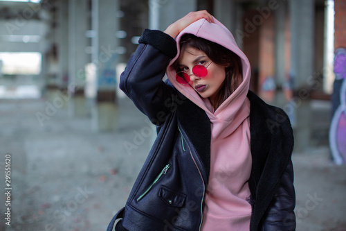 Girl in colored glasses in an abandoned building