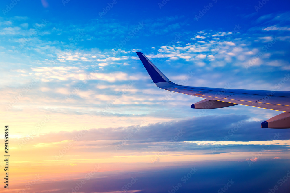 Fototapeta premium View of plane wing and beautiful sky above the clouds from plane in Udaipur ,India