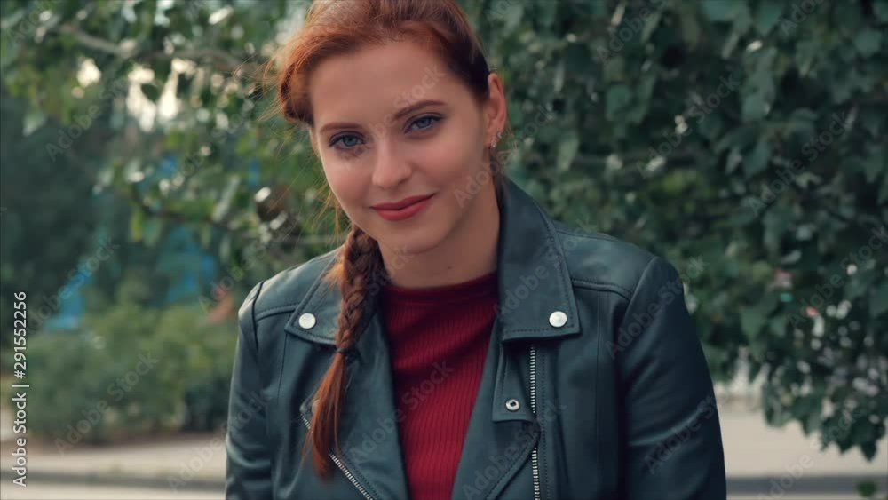 Portrait of an attractive smiling young woman with glasses close-up face of a happy woman with long red hair in a good mood, positive emotions. Portrait of an attractive smiling young woman with glasses close-up face of a happy woman with long red hair in a good mood, positive emotions.