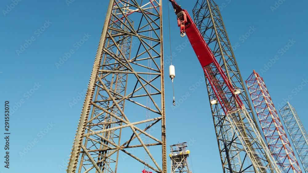 Jack up rig leg and a crane in a shipyard Jack up rig leg and a crane in a shipyard