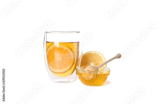 Glass of tea with lemon, honey and dipper isolated on white background © Atlas