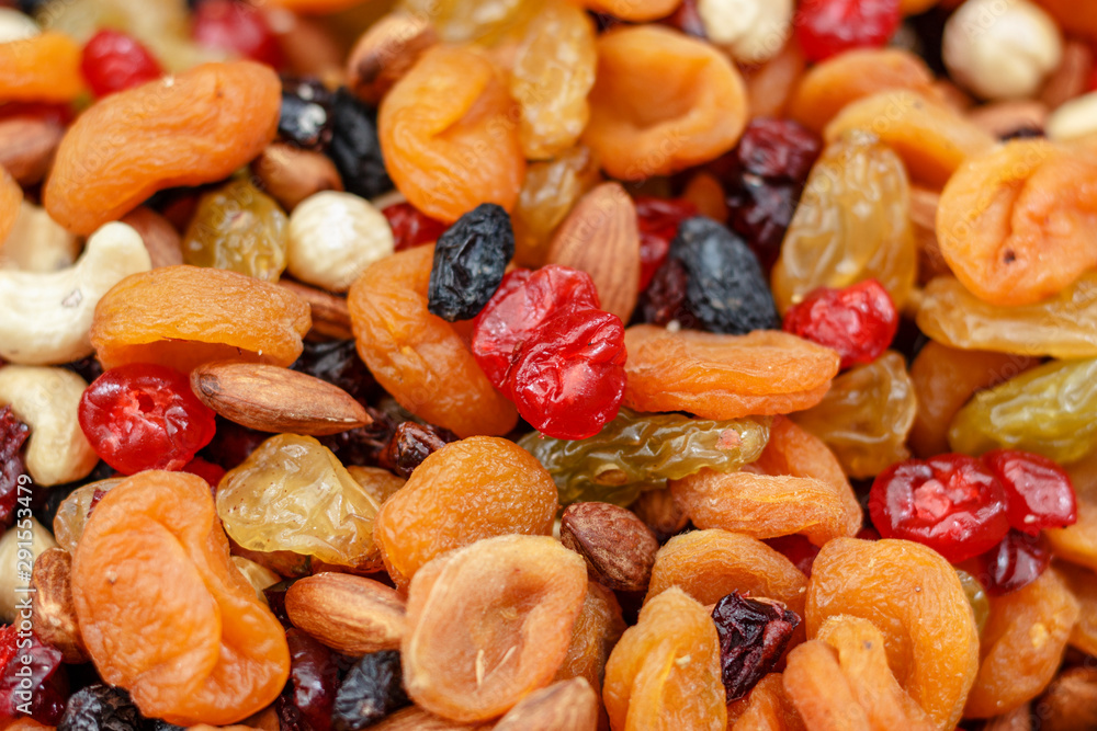 A mixture of dried apricots, raisins and nuts. Background A mixture of dried apricots, raisins and nuts. Background