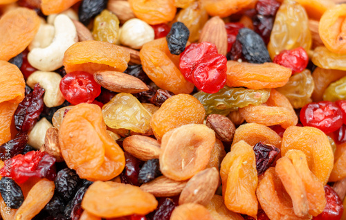 A mixture of dried apricots, raisins and nuts. Background
