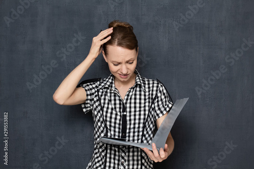 Photography Portrait of frustrated upset girl looking at documents