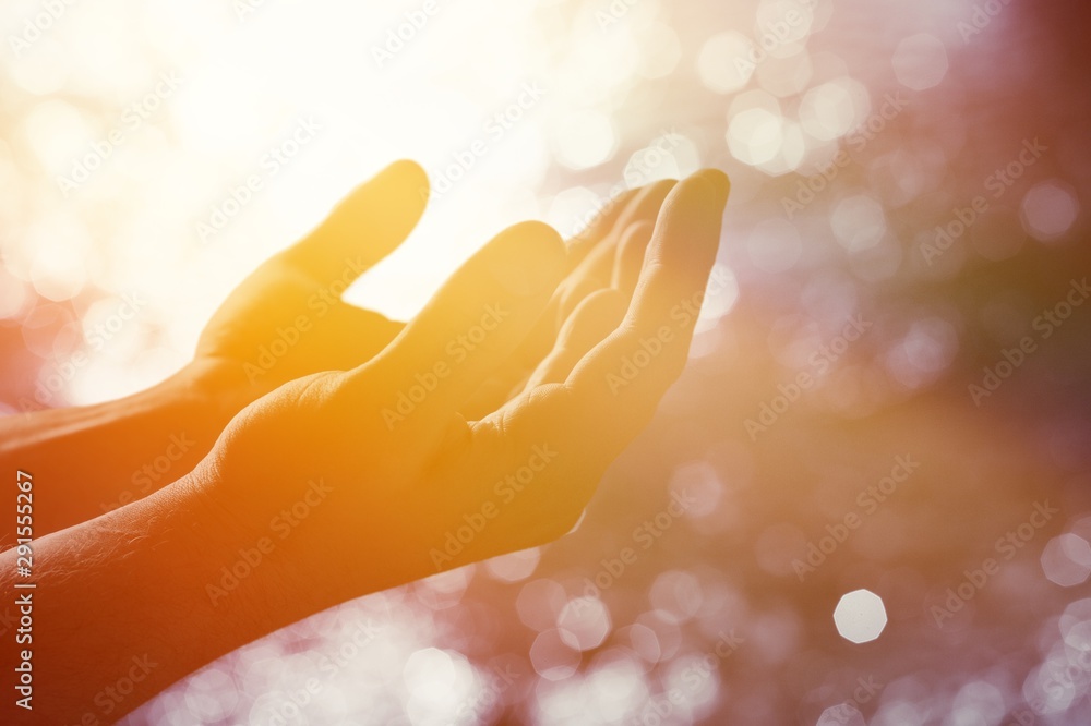 Hands of human praying on blurred background