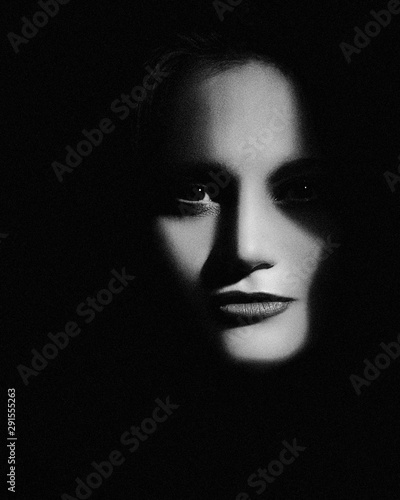 Hiden in the shadows. Horror movie style female portrait