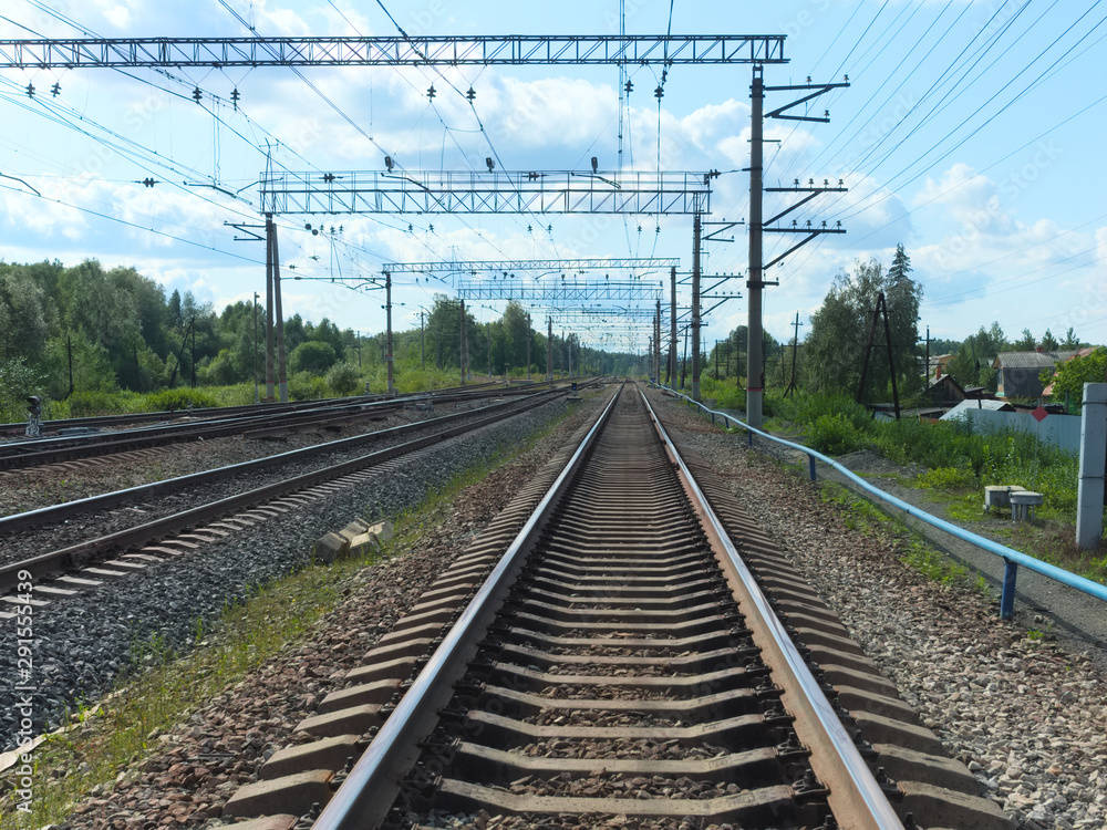 Perspective of railroad tracks going beyond the horizon on a bright sunny day Perspective of railroad tracks going beyond the horizon on a bright sunny day