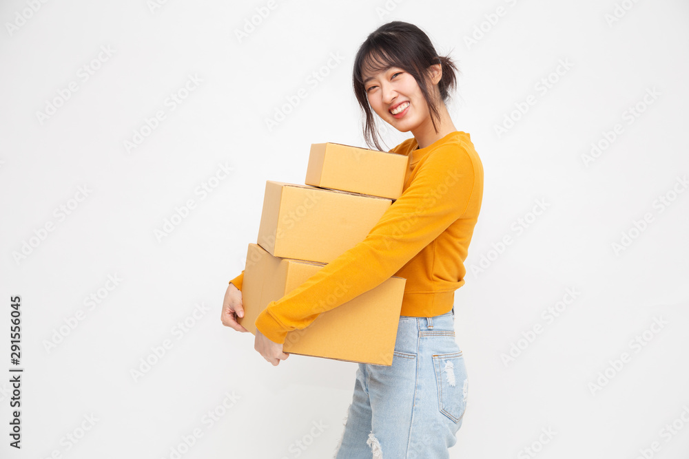 Happy Chinese Asian woman holding package parcel box, Delivery courier and shipping service concept Happy Chinese Asian woman holding package parcel box, Delivery courier and shipping service concept