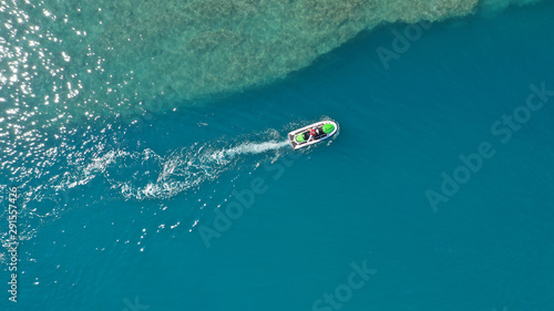 Aerial drone top down photo of jet ski watercraft cruising in high speed in tropical exotic lake © aerial-drone