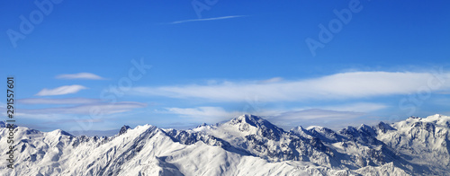 Snowy mountains and blue sky with clouds in nice sunny day © BSANI
