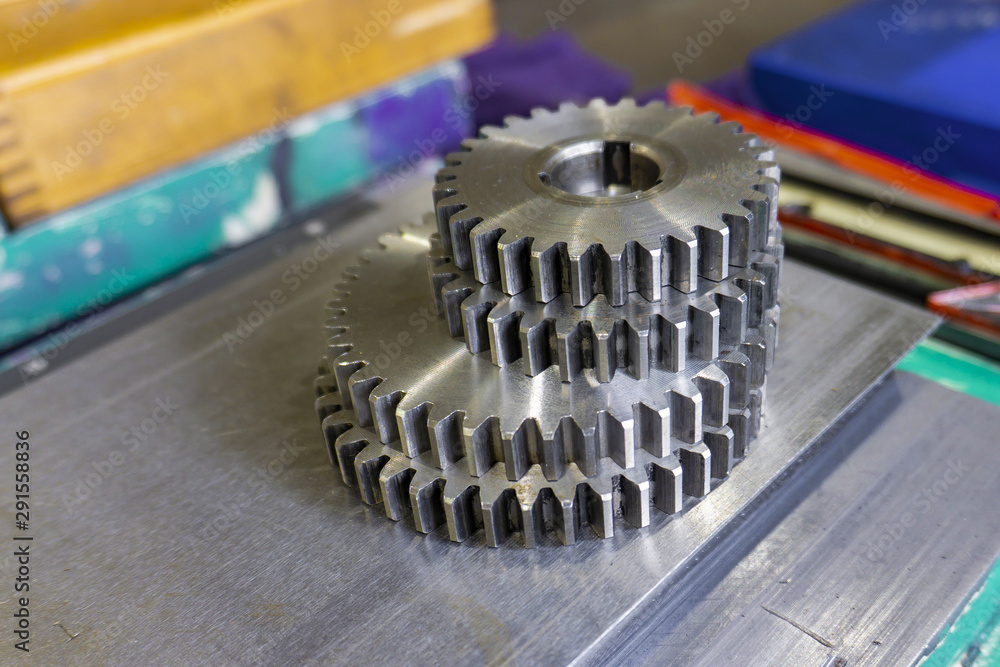 A gear disk with the number of teeth of a metalworking machine lies in the workshop on a guide bed. A gear disk with the number of teeth of a metalworking machine lies in the workshop on a guide bed.
