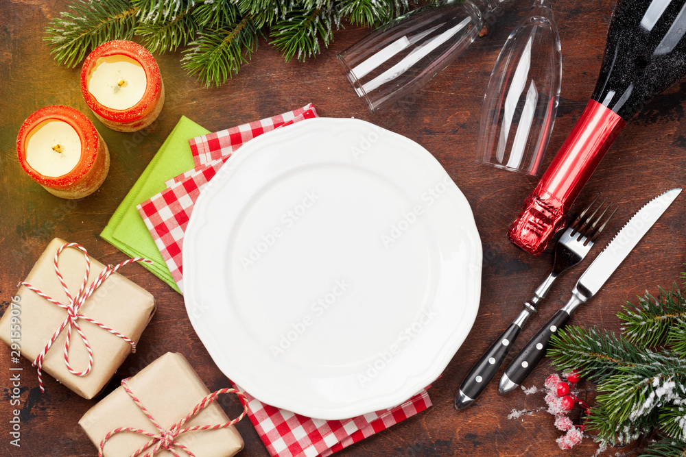 Christmas table setting with champagne and xmas gift Christmas table setting with champagne and xmas gift