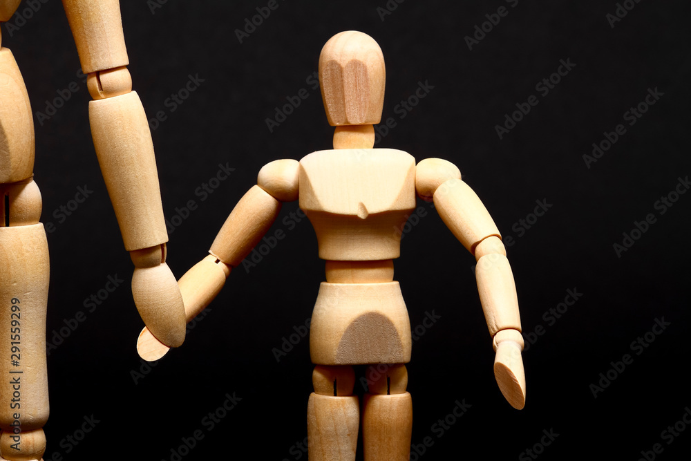 Conceptual image of a manikin parent and child holding hands Conceptual image of a manikin parent and child holding hands