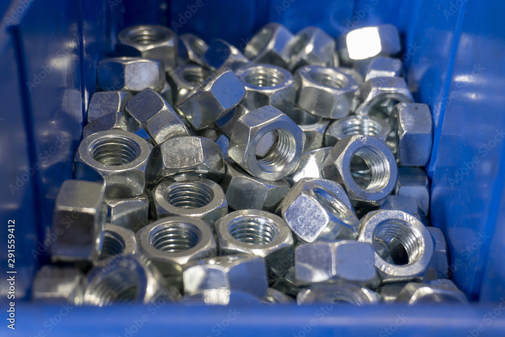 Nut fixing connection, set of new nuts in a blue box. Nut fixing connection, set of new nuts in a blue box.